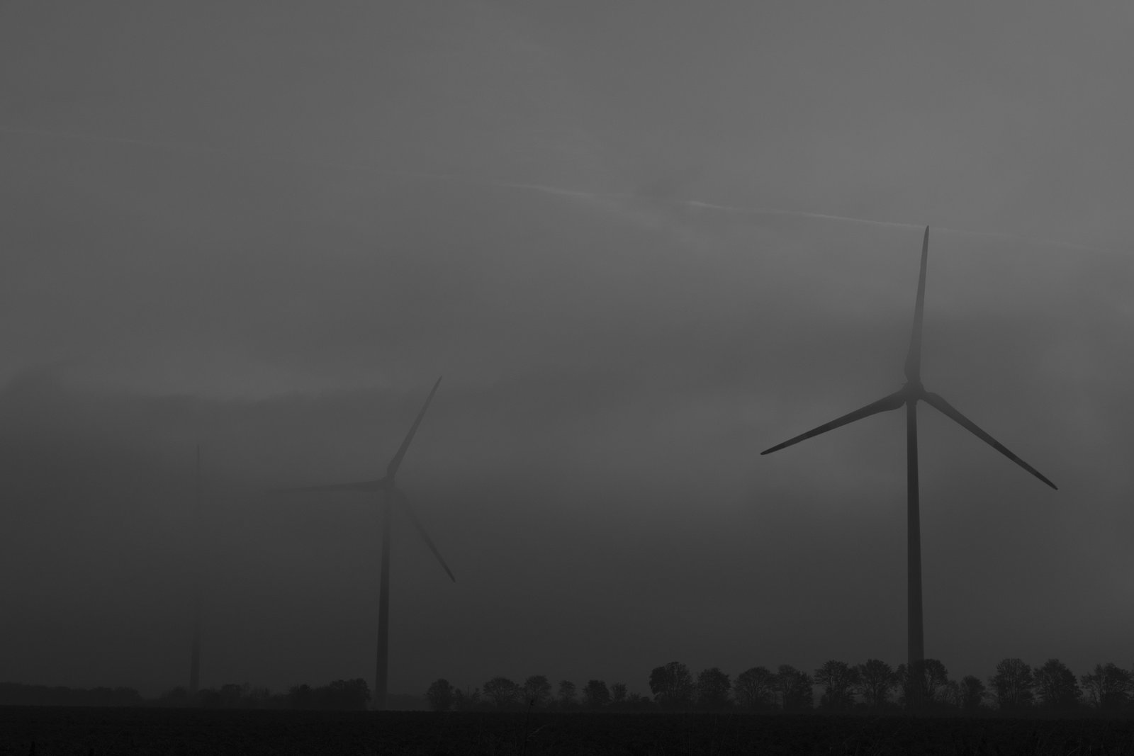 Massive windmills in the mist